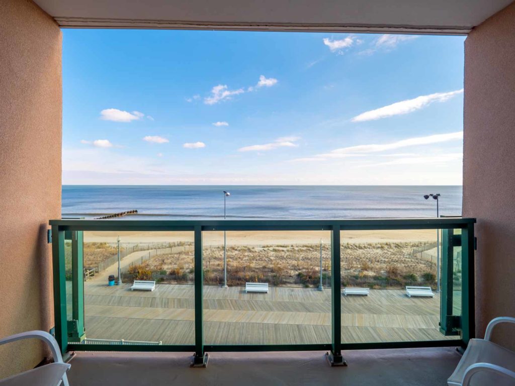 Outward view of Ocean from balcony with two white chairs facing outward